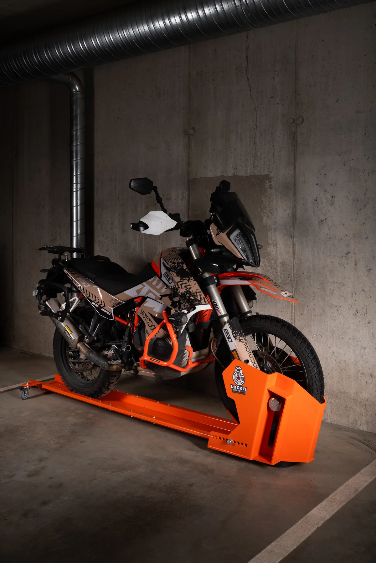 Motorcycle held upright in an orange DockIT parking stand