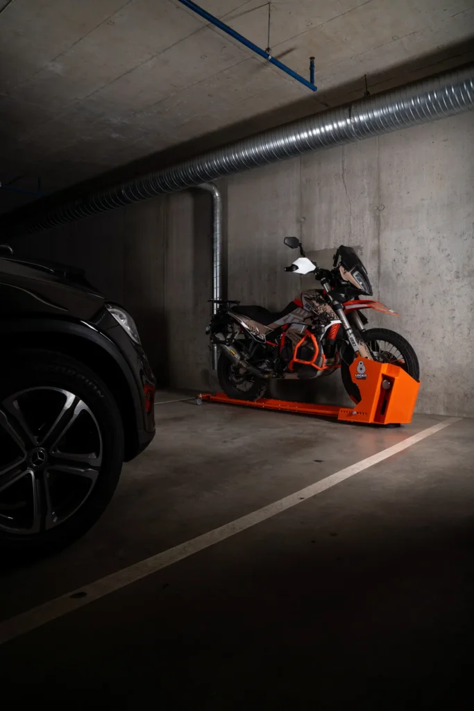Motorcycle rotated on a DockIT stand and parked parallel to the wall