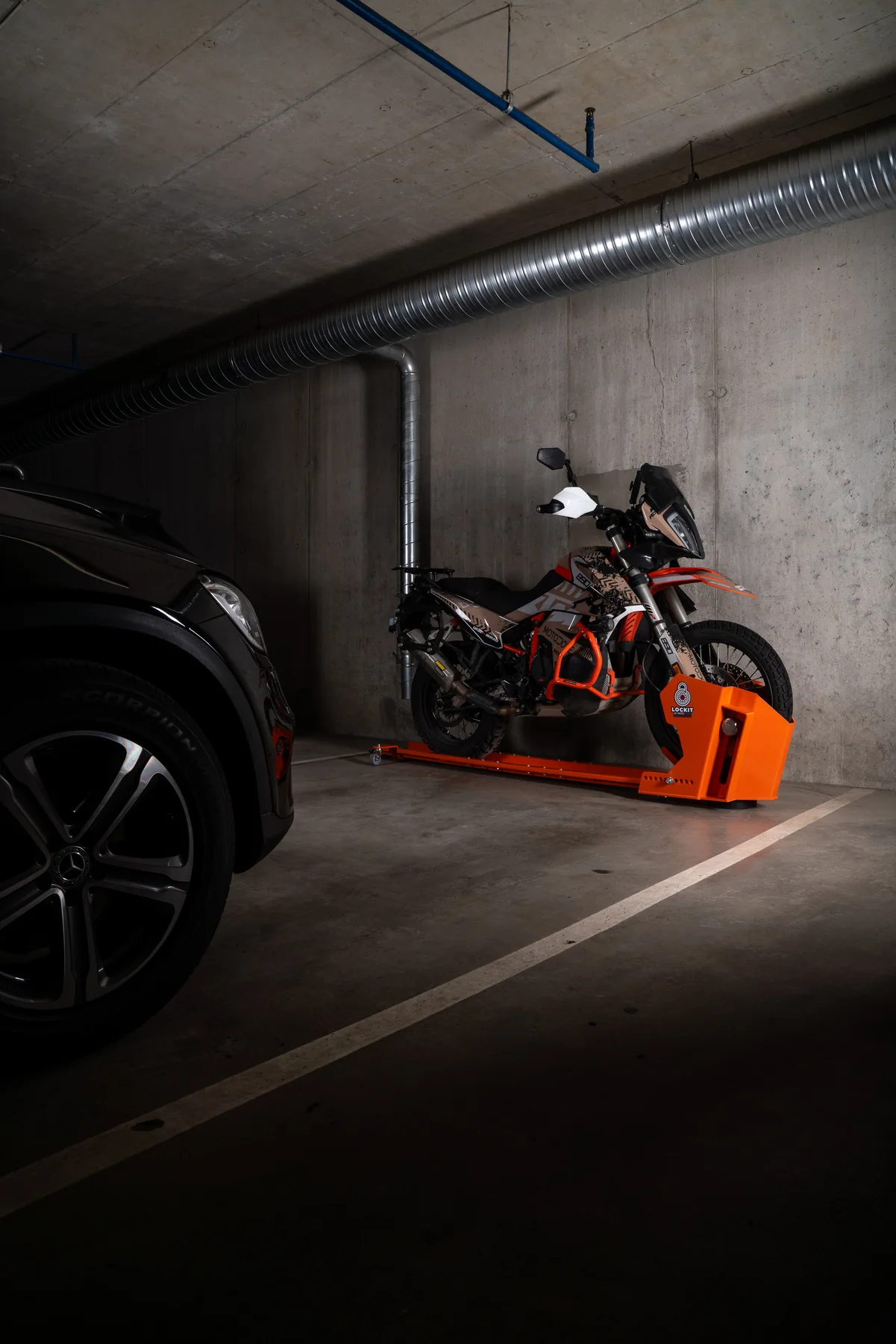 Motorcycle rotated on a DockIT stand and parked parallel to the wall