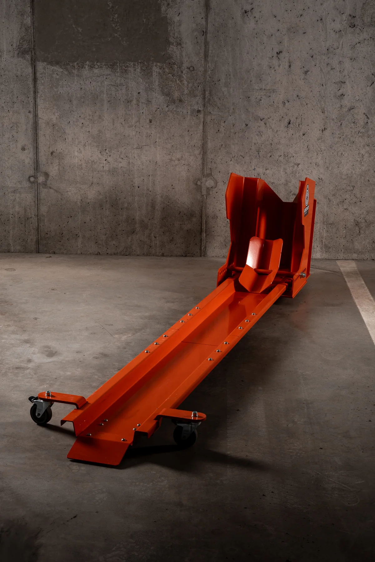 Angled view of the orange DockIT motorcycle parking stand