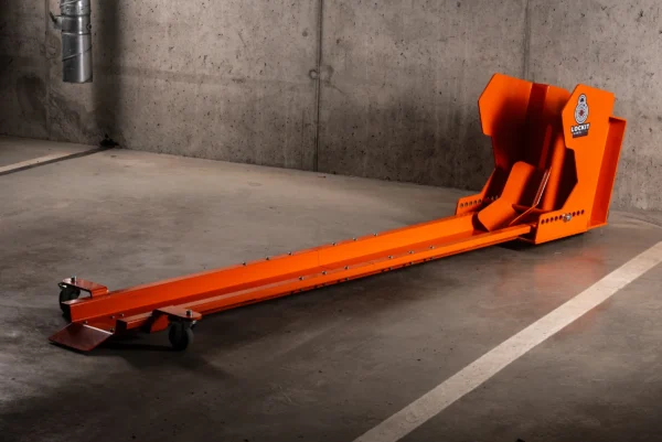Orange DockIT rotating motorcycle parking stand on an underground car park floor