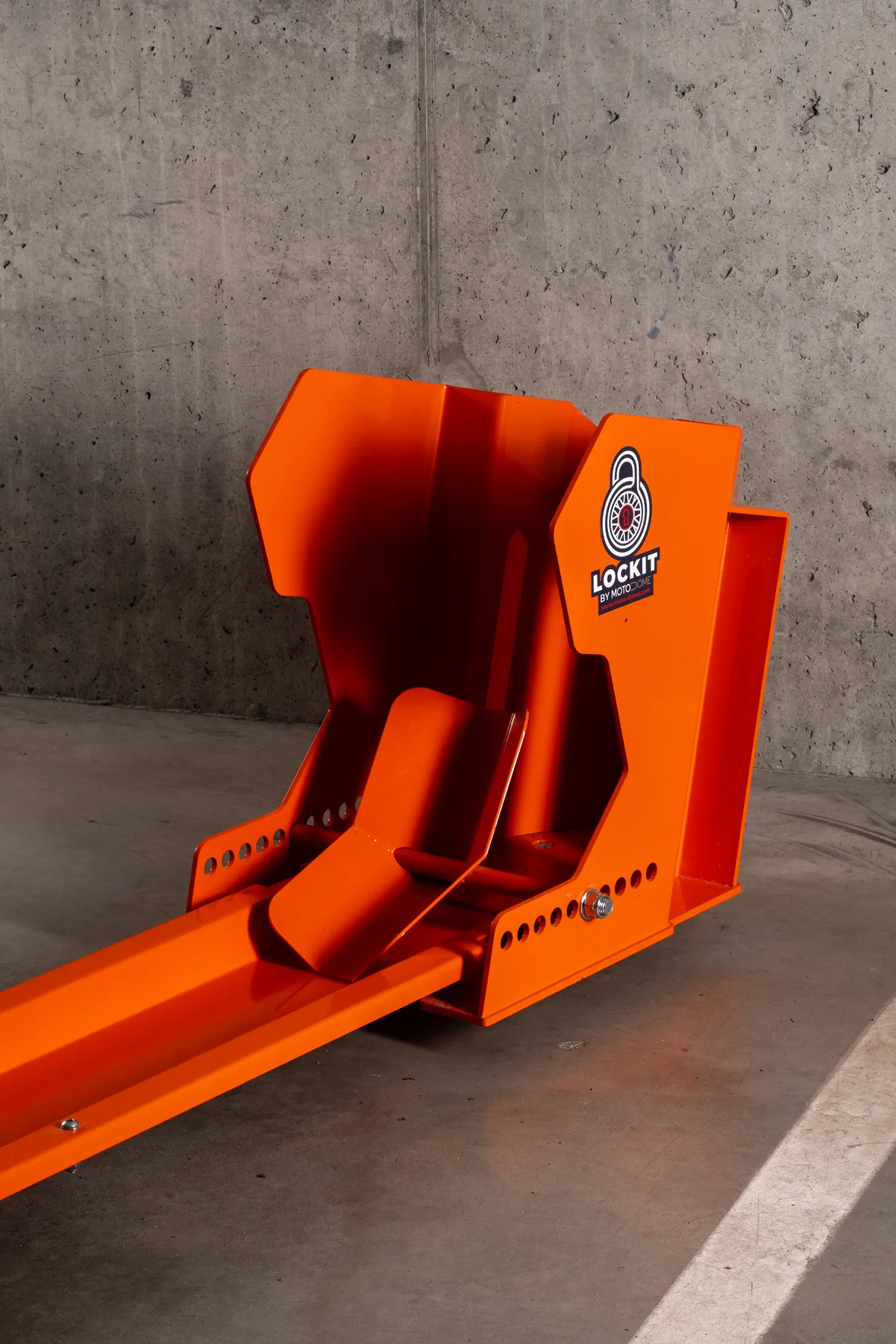 Orange DockIT motorcycle stand photographed on its own