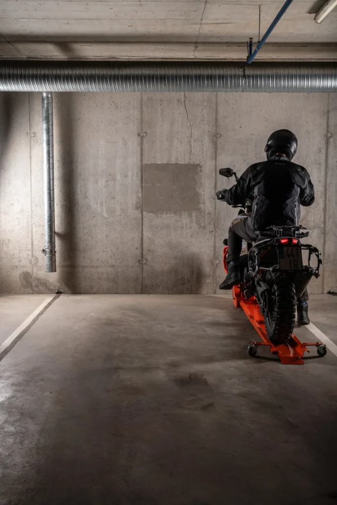 Rider rotating a motorcycle towards the wall on a DockIT stand