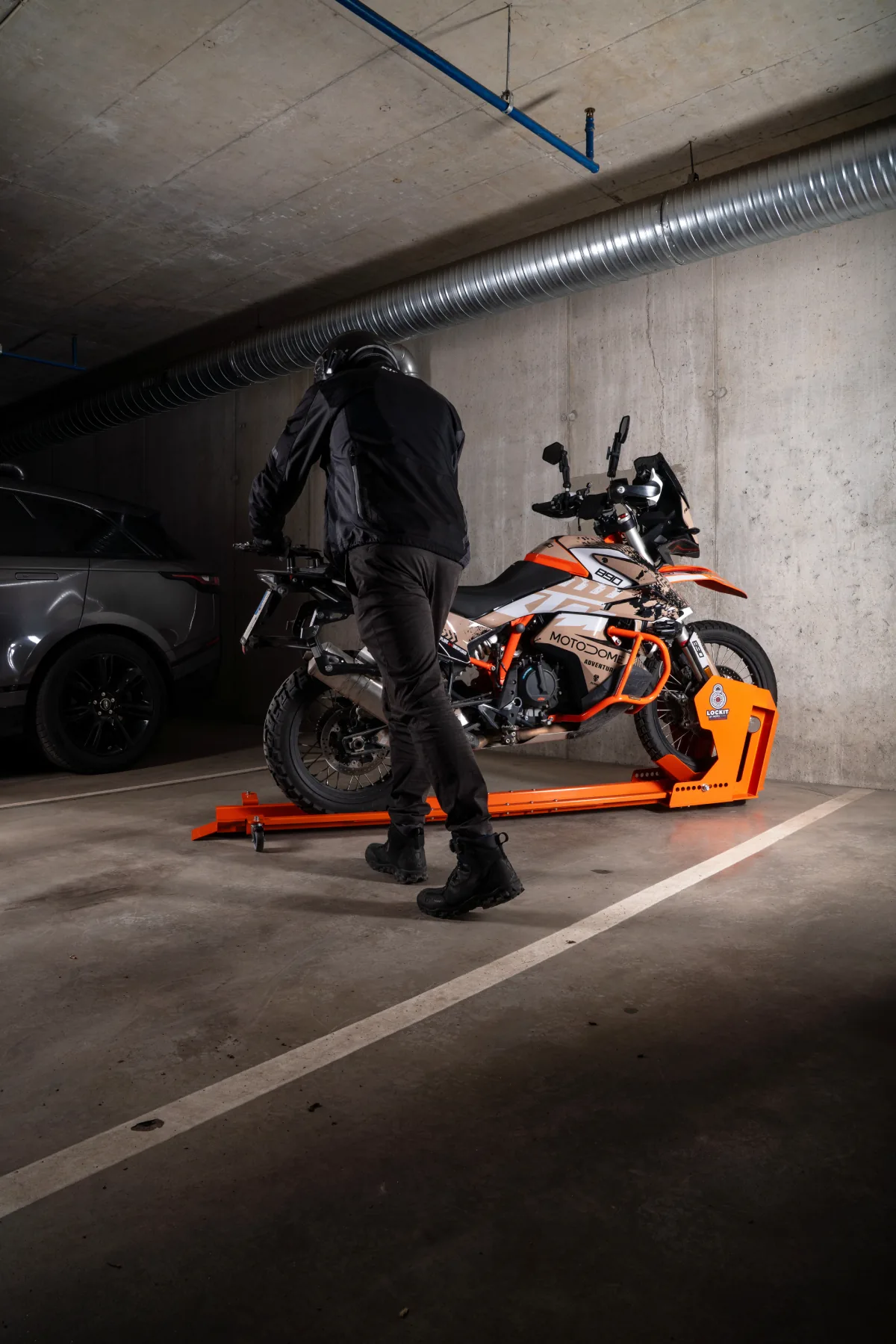 Rider swinging the rear of a motorcycle towards the wall on a DockIT stand