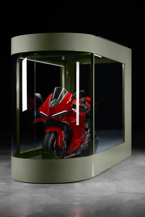 MotoDome glass walls with LED lighting MotoDome glass motorcycle garage lit by ambient LED lighting at night