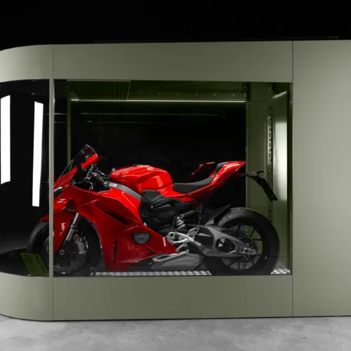 MotoDome with red sportbike inside Red sportbike stored inside an olive MotoDome motorcycle garage with glass walls and LED lighting